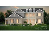 Charming two-story brick home featuring dormer windows, a welcoming porch, and a meticulously landscaped front yard at 2410 Spring Rock Pl # 400, Huntersville, NC 28078
