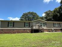 Charming single-story home featuring a well-maintained lawn and cozy front porch at 2418 6Th Sw Ave, Hickory, NC 28602