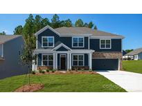 Charming two-story home with a dark blue exterior, brick accents, and a well-manicured lawn at 259 Miramar Dr, York, SC 29745