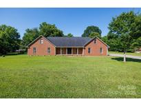 Charming single-story brick home featuring a well-manicured lawn and a classic, inviting front porch at 2765 Dogwood Cir, Rock Hill, SC 29732