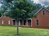 Charming single Gathering home featuring a brick facade and covered porch with manicured lawn at 2765 Dogwood Cir, Rock Hill, SC 29732