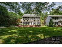 Charming two-story home with shutters, window box planters, brick stairs, and a lush green lawn at 5014 Quail Canyon Dr, Charlotte, NC 28226