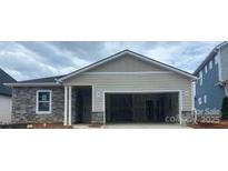 Charming single-story home featuring stone accents and an attached two-car garage, perfect for modern living at 5602 Caneel Ln # 1222, Denver, NC 28037