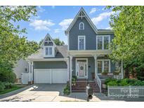 Charming two-story home with a covered porch, a two-car garage, and a beautifully landscaped front yard at 138 Blandina Ct, Fort Mill, SC 29708