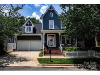 Charming two-story home with a welcoming front porch, two car garage, and professionally landscaped front yard at 138 Blandina Ct, Fort Mill, SC 29708