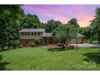 Charming two-story home with brick accents, mature landscaping, and a two-car garage in a beautiful, serene setting at 2109 Quail Nw Dr, Concord, NC 28027