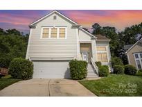 Charming two-story home featuring a well-maintained lawn, attached garage and inviting front entrance at 220 Holmes Ct, Concord, NC 28027