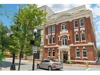 Classic brick building featuring elegant architectural details and well-maintained landscaping at 229 N Church St # 401, Charlotte, NC 28202