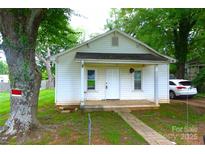 Charming one-story home with a classic design, complemented by a well-maintained front yard and mature trees at 238 Deaton St, Statesville, NC 28677