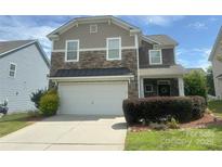 Charming two-story home features a stone facade, attached garage, and well-maintained landscaping at 3009 Canopy Dr, Indian Trail, NC 28079