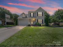 Charming two-story home with a well-manicured lawn and a driveway with a basketball hoop at 3301 Old Knobbley Oak Dr, Gastonia, NC 28056