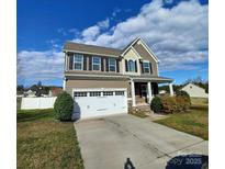 Two-story home with a two-car garage, neutral siding, black shutters, and a covered front porch at 3717 English Garden Dr, Gastonia, NC 28056
