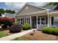 Inviting home exterior featuring manicured landscaping and a charming covered porch at 409 Guiness Pl, Rock Hill, SC 29730