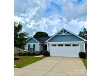Charming single-story home featuring a two-car garage and beautiful blue and gray siding at 4227 Mackinnon Dr, Charlotte, NC 28214