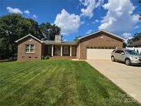 Charming brick home with a well-manicured lawn and inviting stone-accented front porch at 5238 Bethel Church Rd, Hickory, NC 28602