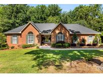 Charming one-story brick home featuring lush landscaping and a well-manicured lawn, perfect for curb appeal at 600 Queens Rd, Cherryville, NC 28021