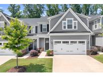 Charming gray two-story home with a well-manicured lawn, two-car garage, and inviting landscaping at 6365 Ashton Park Dr, Denver, NC 28037