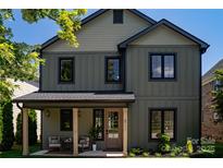 Charming two-story home features a welcoming front porch with stylish seating area and manicured landscaping at 6711 Creft Cir, Lake Park, NC 28079