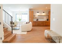 Bright living room featuring modern decor, light wood floors, and an open layout to the dining area at 6711 Creft Cir, Lake Park, NC 28079