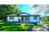 Charming, freshly painted home with well-maintained lawn and inviting front porch at 703 Central Nw Dr, Concord, NC 28027