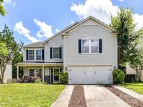 Charming two-story home featuring a well-manicured lawn and a two-car garage at 14307 Hartwell Farm Dr, Charlotte, NC 28278