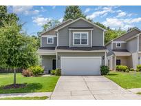 Charming two-story home with two car garage, landscaped yard and inviting curb appeal at 1514 Starmount Cove Ln, Charlotte, NC 28210