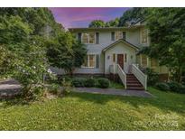 Charming two-story home features lush landscaping, a welcoming entrance, and a serene, tree-lined setting at 204 S Deerfield Cir, Salisbury, NC 28147