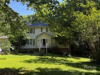 Charming two-story home featuring a well-maintained lawn and mature trees at 204 S Deerfield Cir, Salisbury, NC 28147