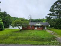 Charming single-story brick home with a well-maintained lawn and mature trees at 2448 Cambridge Dr, Lancaster, SC 29720