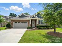 Charming single Gathering home with manicured lawn, brick facade and attached two car garage at 3029 Marchers Trace Dr, Charlotte, NC 28227