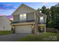 Charming two-story home featuring a two-car garage, landscaped yard, and neutral siding at 329 Brannon Meadows Dr, York, SC 29745