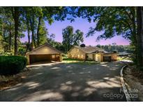 Charming home with a spacious driveway and a detached two-car garage with basketball hoop at 364 Catalina Dr, Mooresville, NC 28117