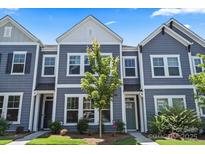 Charming townhome with a neat lawn and light blue exterior at 517 Morrows Turnout Way, Pineville, NC 28134