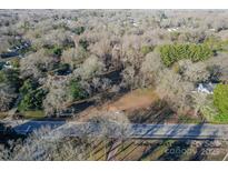 An aerial view displays the property and the lot cleared and ready for building in a quiet wooded neighborhood at 531 Winding Way # 9, Belmont, NC 28012
