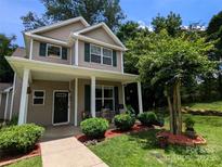 Charming two-story home with covered front porch, lush landscaping, and inviting curb appeal at 725 Chelton Ln, Fort Mill, SC 29715