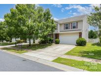 Charming two-story home with a well-manicured lawn and a spacious driveway at 9416 Cotton Gum Rd, Charlotte, NC 28227