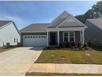Charming single-story home featuring a two-car garage and a welcoming covered entryway at 1070 Bull Dog Ln, Wingate, NC 28174