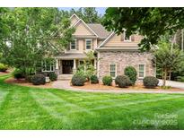 Charming two-story home with stone accents, lush landscaping, and a well-manicured lawn at 109 Trent Pines Dr, Mooresville, NC 28117