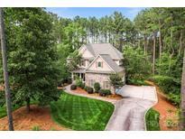 Beautiful two-story home with brick accents, a manicured lawn, and a spacious driveway at 109 Trent Pines Dr, Mooresville, NC 28117