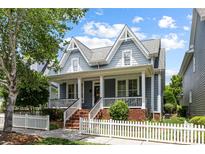 Charming two-story home with a welcoming front porch, a white picket fence, and neatly landscaped yard at 126 Blandina Ct, Fort Mill, SC 29708