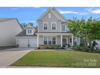 Charming two-story home featuring a two-car garage and landscaped front yard at 1335 Bryson Gap Dr, Fort Mill, SC 29715