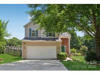 Charming two-story home featuring a two-car garage, green front door, and well-maintained landscaping at 1986 Trace Creek Dr, Waxhaw, NC 28173