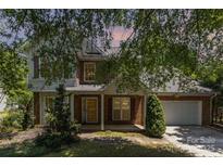 Charming brick and siding two-story home with a well-manicured lawn and a two car garage at 2001 Enderbury Dr, Indian Trail, NC 28079