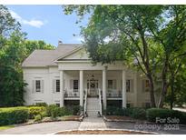 A beautiful white house with a large front porch and columns at 2324 Kingsmill Ter, Charlotte, NC 28270