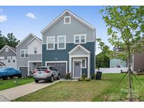 Charming two-story home with a well-manicured lawn and a single-car attached garage in a modern neighborhood at 9025 Henry Thoreau Rd, Charlotte, NC 28214