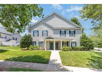 Charming two-story duplex features a well-manicured lawn and classic siding at 9664 Littleleaf Dr, Charlotte, NC 28215
