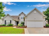 Charming two-story home with manicured lawn and flower beds, showcasing curb appeal and a welcoming entrance at 2026 Rosewater Ln, Indian Trail, NC 28079