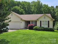 Charming home featuring a well-manicured front yard and attached two-car garage at 217 Rock Creek Dr, Lincolnton, NC 28092