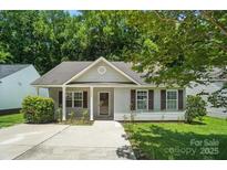 Charming single-story home features light siding, a well-manicured lawn, and a welcoming entrance at 2239 Blue Hampton Ln, Charlotte, NC 28213