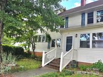 Charming two-story home with white siding, blue shutters, and a well-maintained front yard with a tree at 29 Willow St # 31, Badin, NC 28009